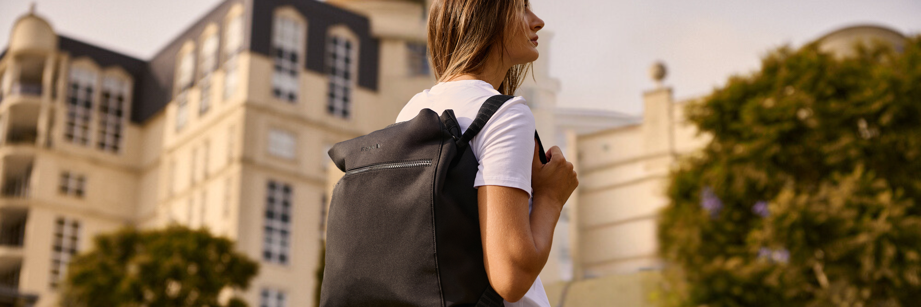 Black Neoprene Bag worn by a woman as a backpack